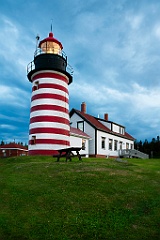 Storm Clouds Gather Around Red and White Striped Lighthouse in N